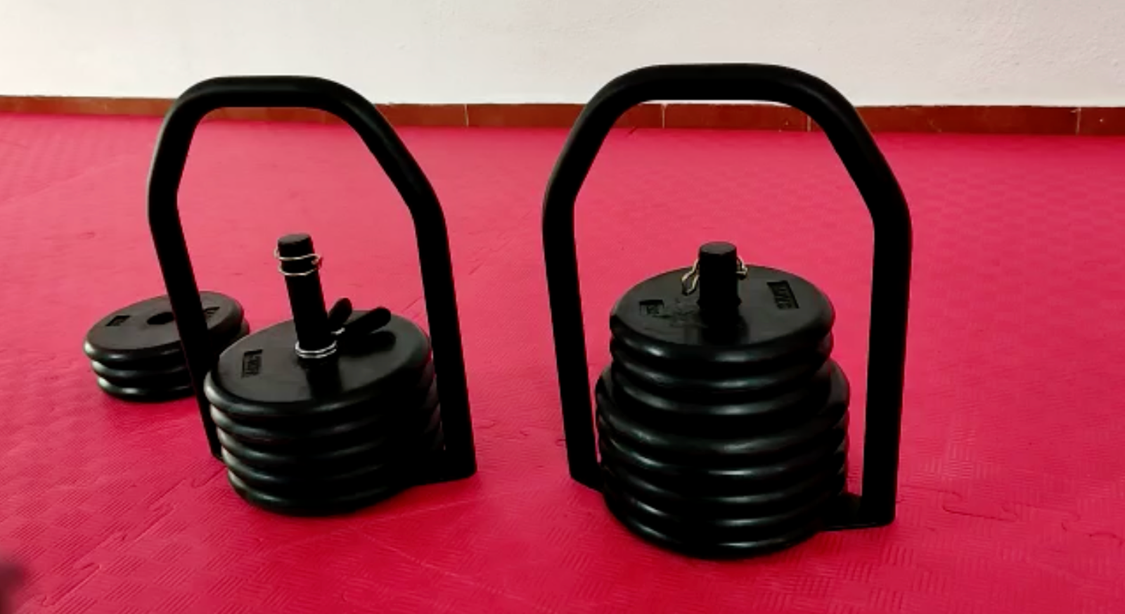Two Regulabell kettlebells loaded at different weights side by side